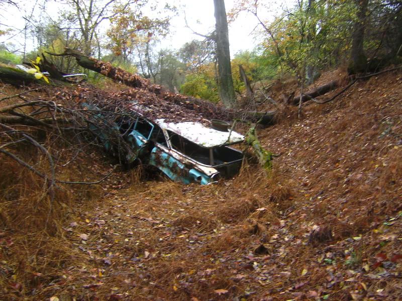 and a pile of abandoned classic cars